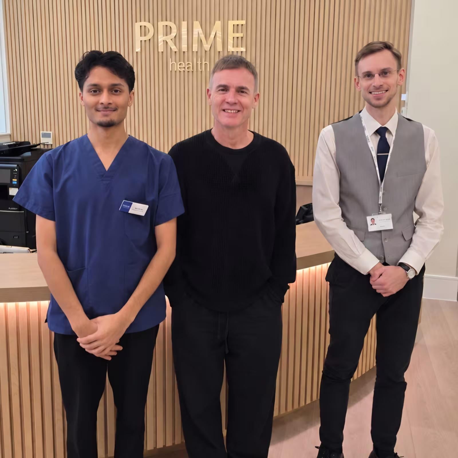 Sahil, Radiographer, and Dominik, Front of House, with Gary Barlow at Prime Health London