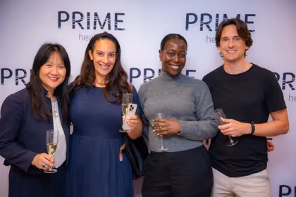 Guests at the Prime Health backdrop