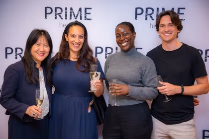 Guests at the Prime Health backdrop
