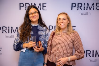 Guests at the Prime Health backdrop