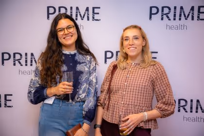 Guests at the Prime Health backdrop