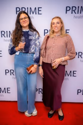 Guests at the Prime Health backdrop