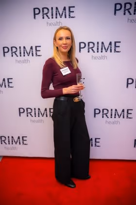 Guests at the Prime Health backdrop