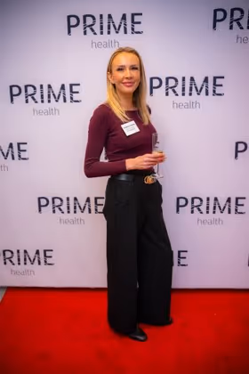Guests at the Prime Health backdrop