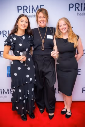 Guests at the Prime Health backdrop