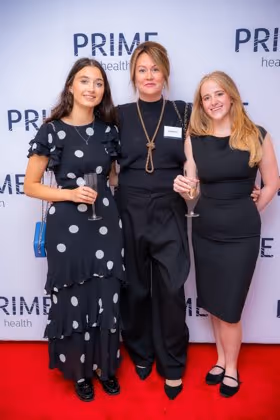 Guests at the Prime Health backdrop