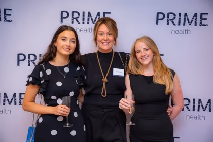 Guests at the Prime Health backdrop