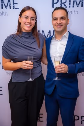 Guests at the Prime Health backdrop