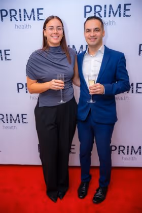 Guests at the Prime Health backdrop