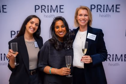 Guests at the Prime Health backdrop