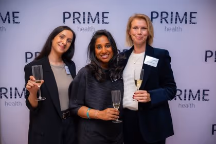 Guests at the Prime Health backdrop