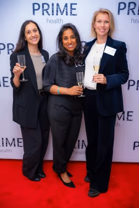 Guests at the Prime Health backdrop