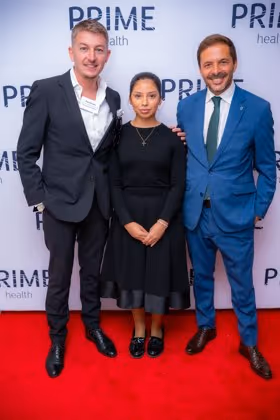 Guests at the Prime Health backdrop