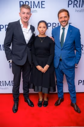 Guests at the Prime Health backdrop
