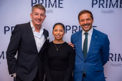 Guests at the Prime Health backdrop
