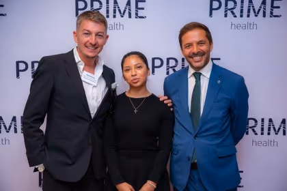 Guests at the Prime Health backdrop