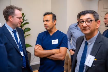 Guests at the Prime Health backdrop